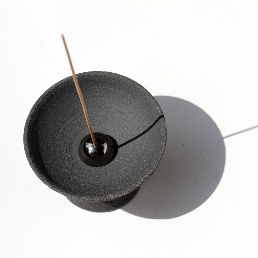 Løft dine røgelsesritualer til et nyt niveau med Shibui Raw Black stentøjs skål & Dome røgelsesholder fra UME Collection. Et perfekt valg til at skabe ro og stil i dit hjem.