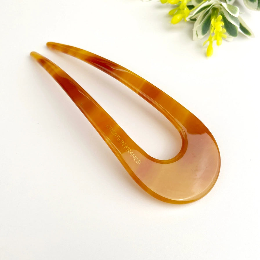 Fransk hårnål i bæredygtig bioplast. Elegant U-formet design, der holder håret naturligt og sikkert på plads – stilfuld og skånsom håropsætning.